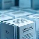 Close up of pharmaceutical packages being loaded into a cold storage unit